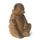 A rare stoneware child's hot water bottle in the form of a teddy bear with white glazed nose and