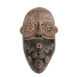 African Art / Tribal Art: A large African mask with perforations and incised carving . 33cm high.