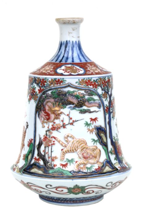 A 19th century Japanese Imari Tokkuri decorated with figures and moulded tigers and dragons, six