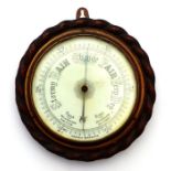 A Victorian wall mounted aneroid barometer with white ceramic dial fitted an oak rope twist case,