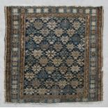 A Persian prayer rug with repeating geometric shapes on a blue ground within a multi border, 127