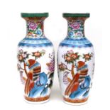 A pair of Japanese baluster form vases decorated with exotic birds, flowers and foliage, each