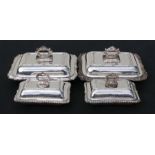 A pair of heavy quality silver plated entrée dishes of rectangular form with scroll rims; together