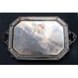 A large silver plated rectangular two-handled tray with canted corners and pierced border, on scroll