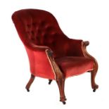 A Victorian upholstered button back armchair with walnut frame and scroll arms on cabriole legs