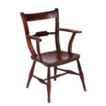 A 19th century Oxford kitchen open armchair with solid elm seat on ring turned legs.