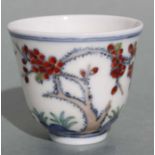 A Chinese Doucai glazed tea bowl decorated with fruit and trees, six character mark to the