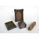 Two silver photo frames, a table top silver cigarette box and a silver backed brush (4)