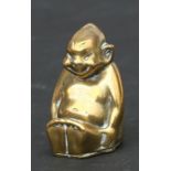 A rare Edwardian brass vinaigrette in the form of a Billiken, 4cms high.