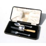A child's silver four-piece christening set comprising knife, fork, spoon and napkin ring, cased.