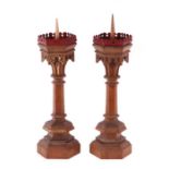 A pair of Victorian Gothic Revival carved oak pricket candlesticks, each approximately 60cm high (