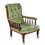 A late Victorian button back upholstered open armchair on turned front legs.