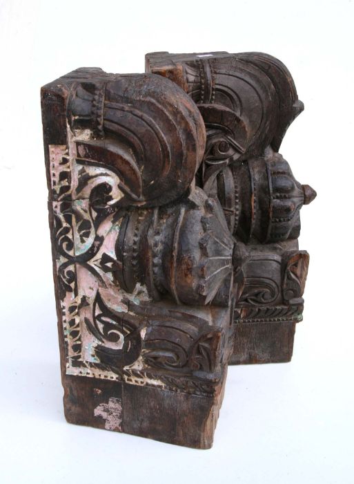 A pair of Indian carved hardwood temple corbels with remnants of paint, 47cms high (2). - Bild 2 aus 2
