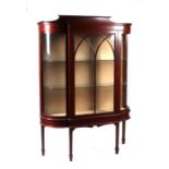 An Edwardian Maple & Co. inlaid mahogany display cabinet with bowed corner glass panels standing