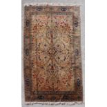 A fine quality Indian hand knotted rug with stylised trees, deer and birds on a light brown ground