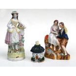 Two Staffordshire figures; together with a Staffordshire pastille burner, the largest 26cms high (