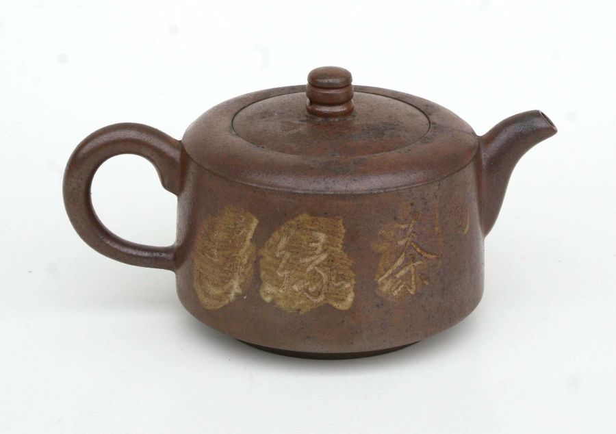 A Chinese Yixing pottery teapot decorated with figures and calligraphy, impressed seal mark to the