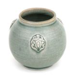 A Chinese celadon glaze vase of globular form with applied motifs, 11cms high.