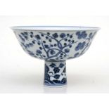 A Chinese blue and white stem bowl, decorated flowering foliage with six character blue mark, 18cm