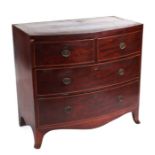 A Regency Mahogany bowfronted chest with two short and two graduated long drawers on splay bracket