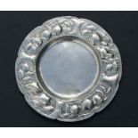 A circular silver plated tray, the rim with embossed and repousse berries and foliage decoration,