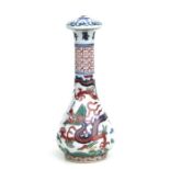 A Chinese Wucai porcelain calligraphy brush handle decorated with a dragon amongst clouds chasing