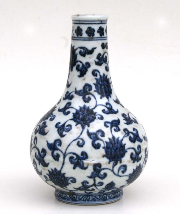 A Chinese blue and white bottle vase decorated flowering scrolling foliage (AF) 20cm high