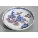 A Chinese blue white and red footed bowl, decorated immortals fighting amongst the clouds with six