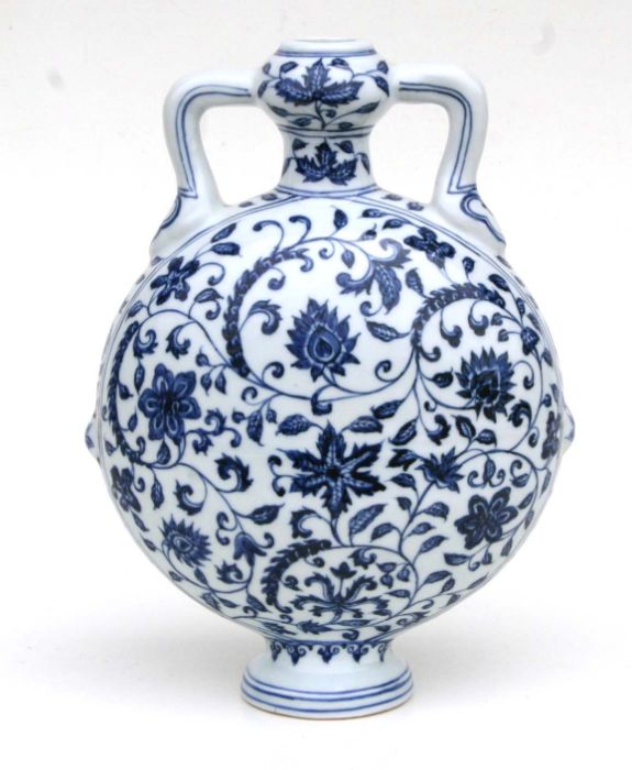 A Chinese blue and white moon flask decorated scrolling flowering foliage, 29cm high