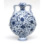 A Chinese blue and white moon flask decorated scrolling flowering foliage, 29cm high