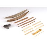 A quantity of Inuit carved bone items & tools; together with a small carved stone bird.