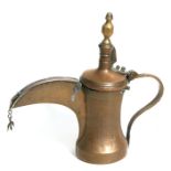 A Turkish/Islamic brass dallah coffee pot, 26cm high