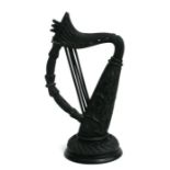 A Victorian Irish bog oak harp carved with scrolling shamrocks, 22cms high.