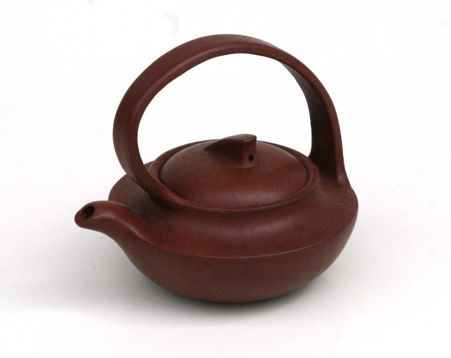 A Chinese Yixing pottery tea pot with impressed seal mark to the underside, 11cm high Condition