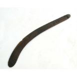 An Austrialian Aboriginal boomerang with simple carved decoration depicting fish, 80cm long