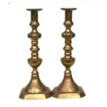 A pair of Victorian brass ejector candlesticks, 35cms high.