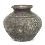 An Indian copper pot with relief decoration, 13cms high.