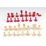 A late 19th century matched natural and stained bone chess set, king height 5cms, in a mahogany