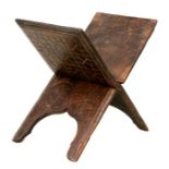 A hardwood folding Koran stand with simple carved decoration, 43cm high