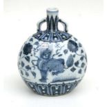 A Chinese blue and white two handled vase, decorated flowering foliage and temple lions, 28cm high