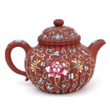 A Chinese Yixing pottery teapot with foliate enamel decoration, four character mark to the