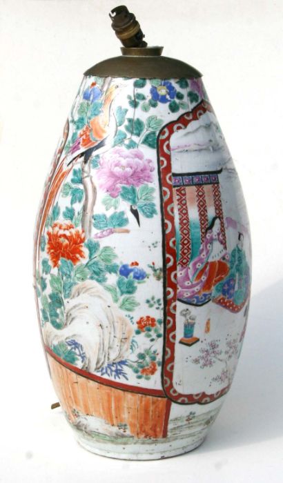 A large Japanese vase decorated with figures within a mountainous landscape and exotic birds