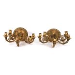 A pair of five-branch bronze wall sconces with lion masks and stylised birds, 36cms wide (2).