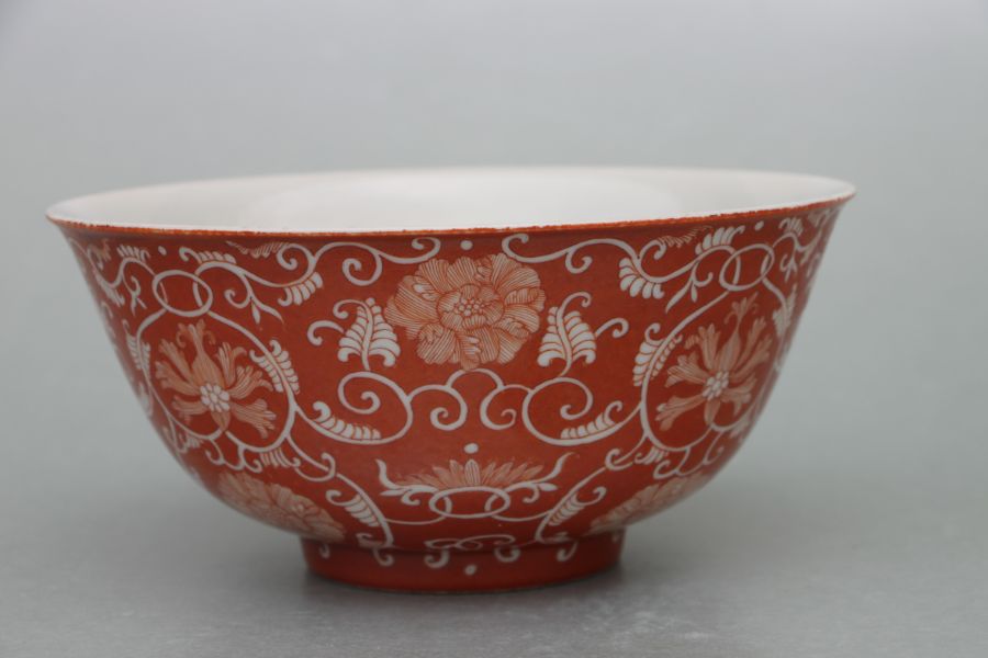 A Chinese footed bowl decorated with scrolling flowering foliage on a burnt orange ground, six - Image 2 of 7