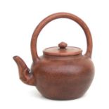 A Chinese Yixing pottery teapot with incised character mark to the underside, 17cms high.Condition