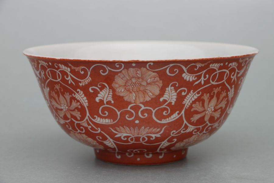 A Chinese footed bowl decorated with scrolling flowering foliage on a burnt orange ground, six - Image 6 of 7