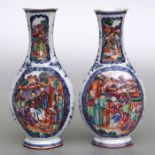 A pair of Chinese blue & white vases with figural panels depicting robed figures seated on a