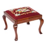 A mahogany footstool with needlepoint upholstered seat, on cabriole legs, 49cms wide.