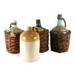 A White & Sons of Newbury stoneware flagon, 31cms high; together with three continental wicker cased