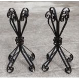 A pair of wrought iron stands, 83cms high (2).